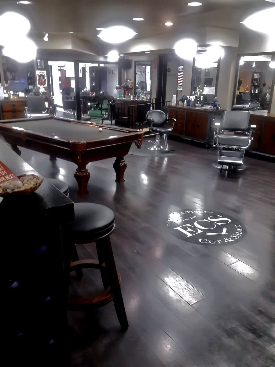 Interior of a barbershop after a full cleaning by Cyclone Janitorial in Santa Clarita, featuring polished floors and organized stations.