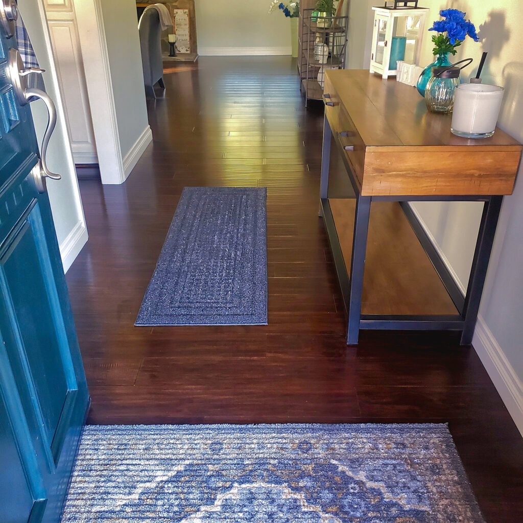 Immaculate entryway with polished wood floors and a neatly arranged console table, cleaned to perfection by Cyclone Cleaning & Janitorial.