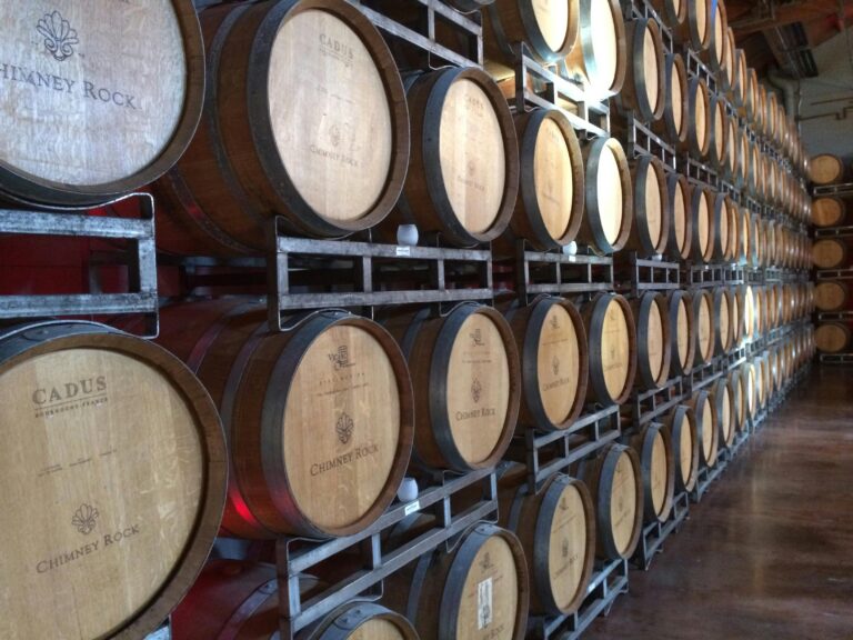 Rows of wine barrels at a small California winery, representing the importance of protecting local businesses through comprehensive insurance claims.