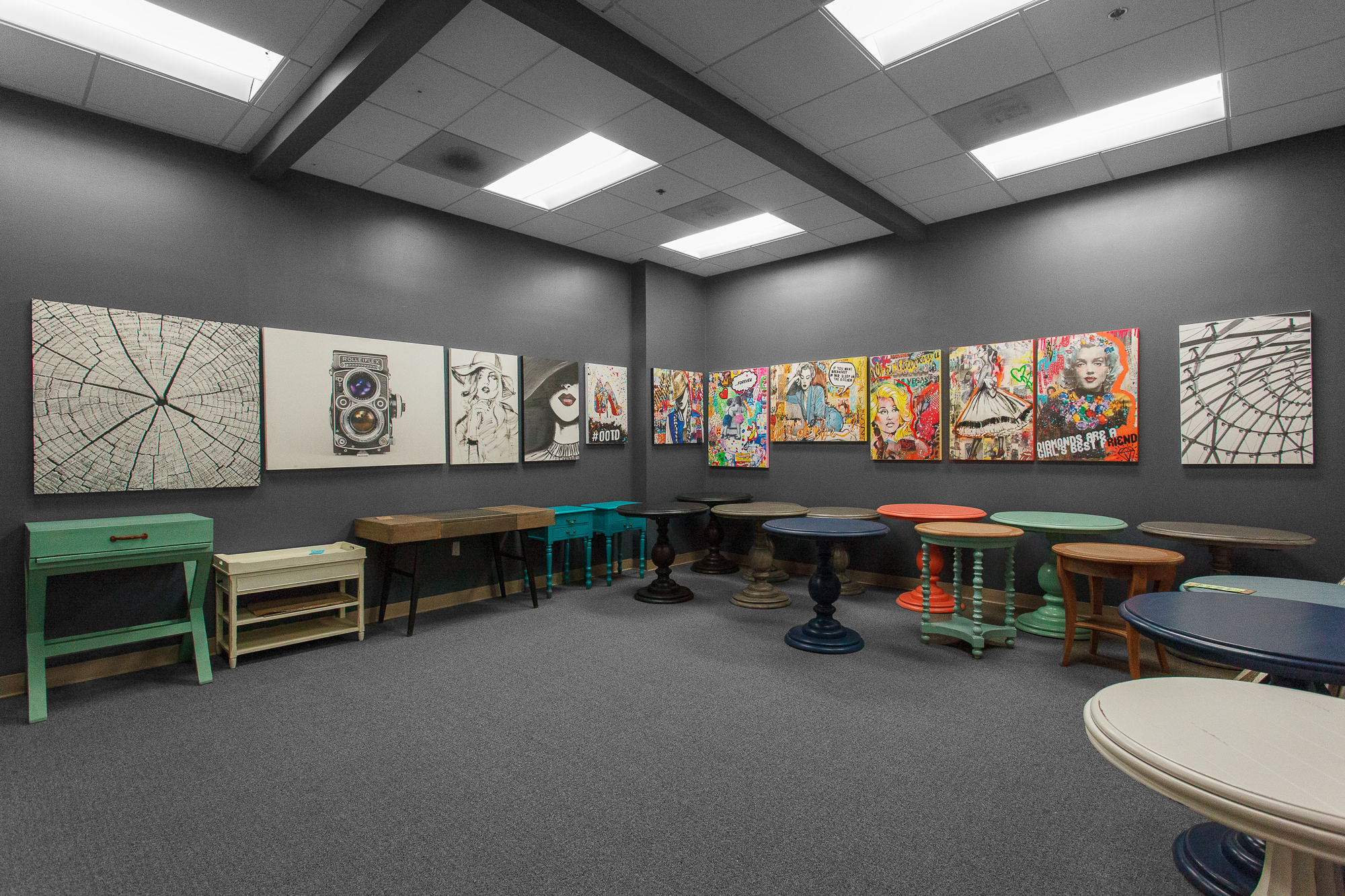 A bold mix of painted reclaimed wood dining tables and chairs, in aqua, yellow, and deep red hues.