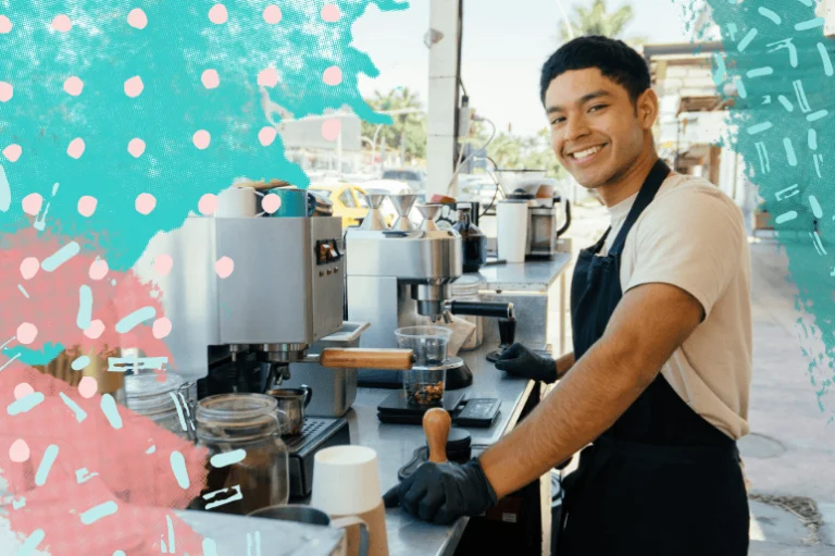 Smiling barista preparing coffee at a local coffee shop counter