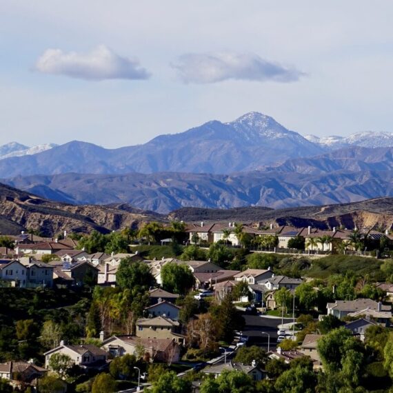 Overlook of a neighborhood in the Santa Clarita Valley, with a mountain vista in the background.