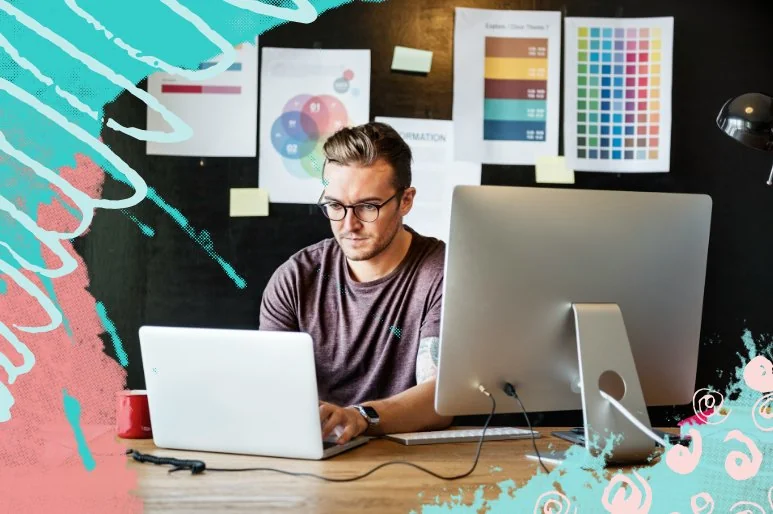 A sole proprietor working on his laptop and desktop computers with an uncertain look on his face.